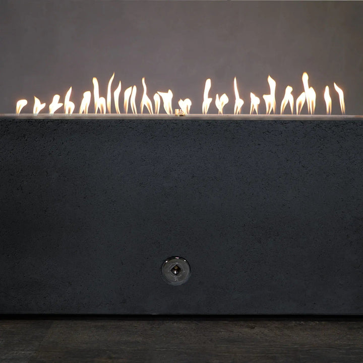 Front view of the Starfire Designs Concrete Rustic 72-inch x 38-inch Rectangle Gravity Gas Fire Pit in Graphite, showcasing the elegant flames dancing across the wide burner in a stylish graphite finish for a warm, inviting ambiance