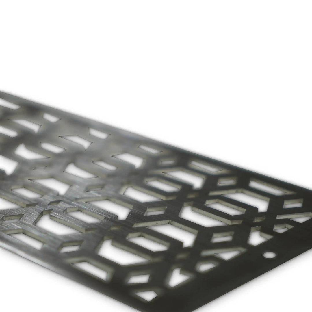 Close-up angled view of the Starfire Designs Decorative Fire Pit Venting Panel - Arbor. This stainless steel fire pit venting panel features a unique arbor pattern, enhancing airflow for outdoor fire pits. Ideal for large gas fire pits, outdoor fire bowls, and patio fire pits