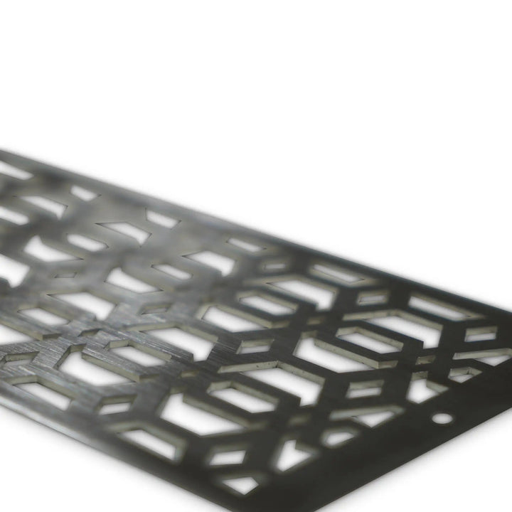 Close-up angled view of the Starfire Designs Decorative Fire Pit Venting Panel - Arbor. This stainless steel fire pit venting panel features a unique arbor pattern, enhancing airflow for outdoor fire pits. Ideal for large gas fire pits, outdoor fire bowls, and patio fire pits