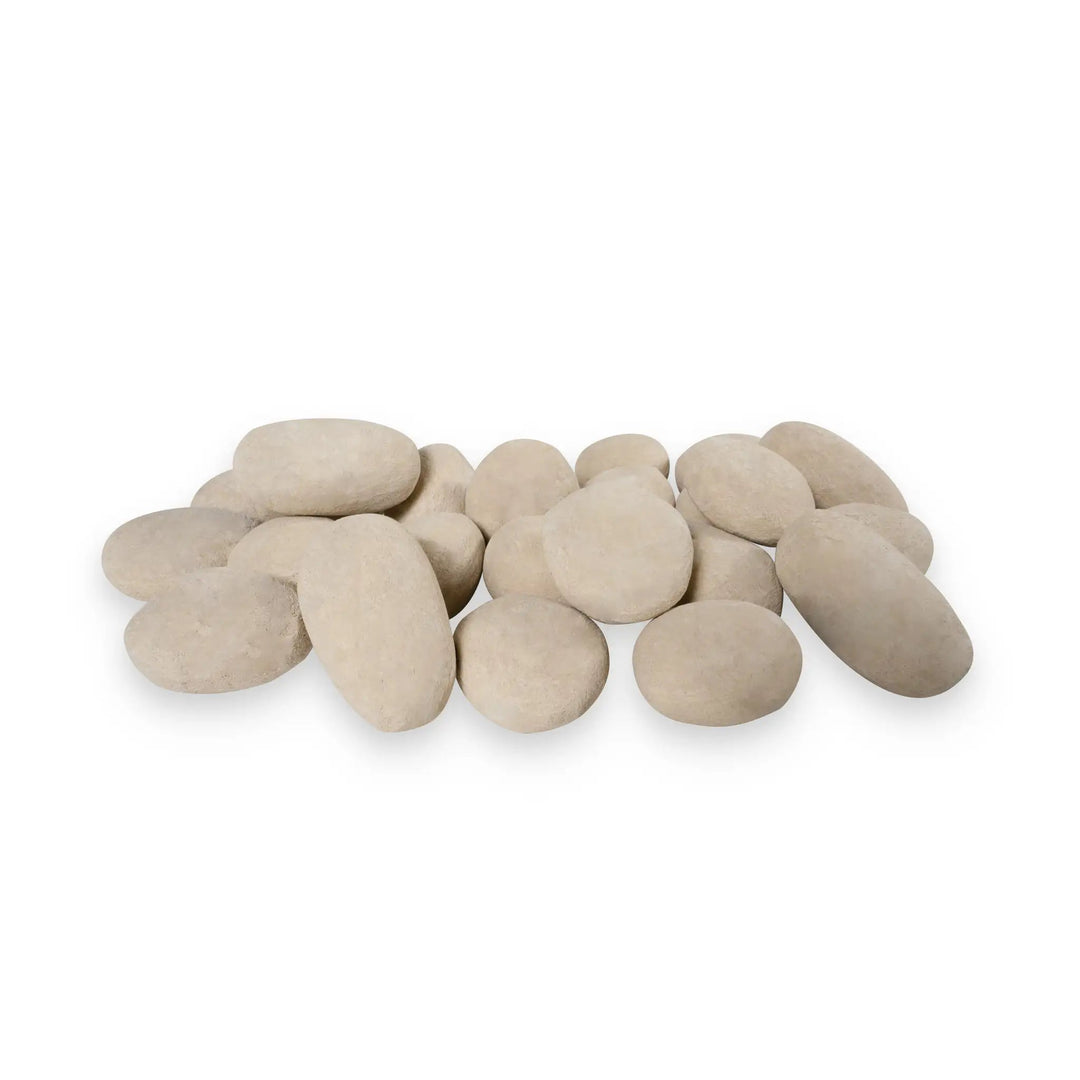 A collection of 24 beige-colored fire pebbles arranged in a random pile, featuring a natural stone-like appearance. These ceramic fire pebbles are designed for outdoor fire pits, adding a soft, organic touch to the fire pit's aesthetic. Ideal for use in modern and contemporary outdoor spaces, these heat-resistant fire pebbles are durable and enhance the overall look of fire feature