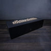 A modern rectangular fire pit filled with beige fire pebbles, without flames, showcasing the natural texture and smooth surface of the fire-resistant ceramic pebbles. The fire pit provides a clean, minimalistic look, perfect for contemporary outdoor settings. These fire pebbles are ideal for enhancing the aesthetic of any fire feature