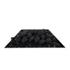 A front-facing view of the Starfire Designs Fire Pebbles set in black, arranged atop black fire glass on a sleek black tray. The smooth, round pebbles stand out, offering a modern aesthetic to any fire feature. Suitable for both indoor and outdoor use in fire pits or decorative bowls.