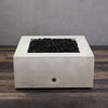 Top-down view of the Starfire Designs Gravity 36" Square Concrete Gas Fire Pit showcasing the clean, smooth white concrete and lava rock fill. Ideal for outdoor patios and landscape designs. 