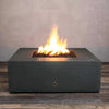 Front view of Starfire Designs Gravity 45-inch square concrete gas fire pit in graphite finish with bright orange flames. The robust fire pit showcases a modern design, providing a sleek addition to any outdoor space with lava rocks in the burner. Ideal for residential and commercial use, this durable fire pit creates a captivating focal point for gatherings