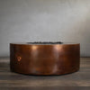 Gravity Moreno 45-inch round copper fire pit by Starfire Designs, featuring a sophisticated hammered copper finish, displayed without the flame, showcasing its sleek and durable design for modern outdoor living spaces