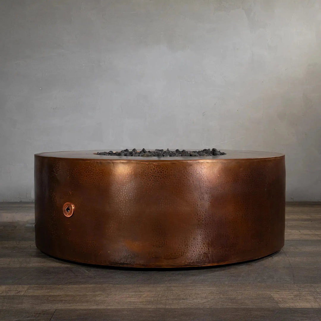 Gravity Moreno 45-inch round copper fire pit by Starfire Designs, featuring a sophisticated hammered copper finish, displayed without the flame, showcasing its sleek and durable design for modern outdoor living spaces