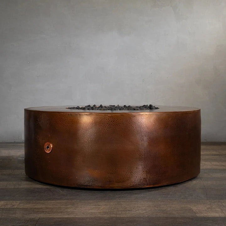 Gravity Moreno 45-inch round copper fire pit by Starfire Designs, featuring a sophisticated hammered copper finish, displayed without the flame, showcasing its sleek and durable design for modern outdoor living spaces