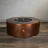 Side view of the Gravity Moreno 45-inch round copper fire pit by Starfire Designs, highlighting its hammered copper finish and circular design, perfect for enhancing any outdoor living space