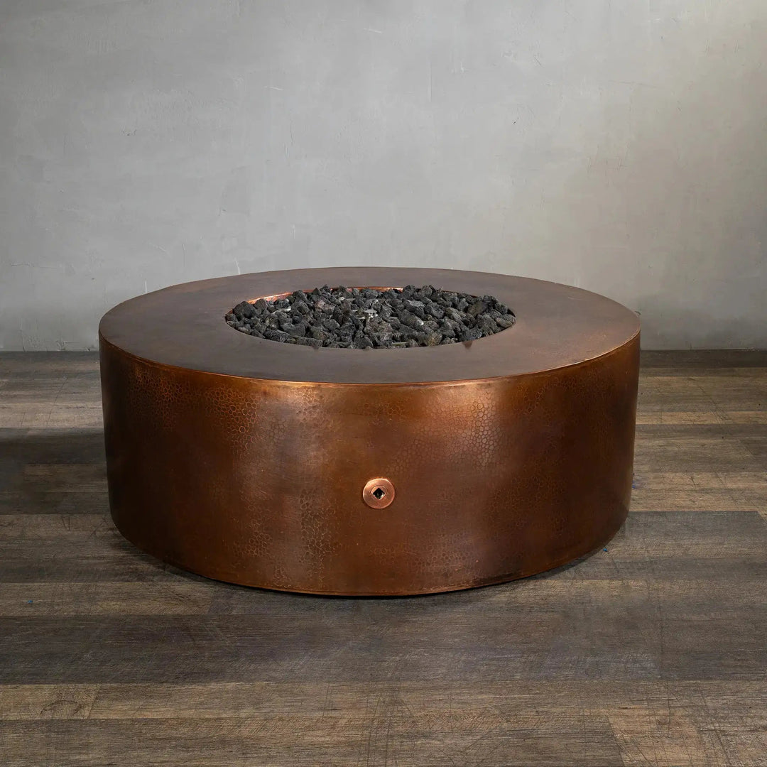 Side view of the Gravity Moreno 45-inch round copper fire pit by Starfire Designs, highlighting its hammered copper finish and circular design, perfect for enhancing any outdoor living space