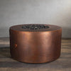 Side view of the Gravity Moreno 45-inch round copper fire pit by Starfire Designs, displaying the intricate copper finish and unlit fire pit, emphasizing the craftsmanship and texture of the fire pit when not in use