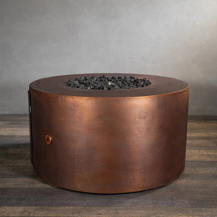 Side view of the Gravity Moreno 45-inch round copper fire pit by Starfire Designs, displaying the intricate copper finish and unlit fire pit, emphasizing the craftsmanship and texture of the fire pit when not in use