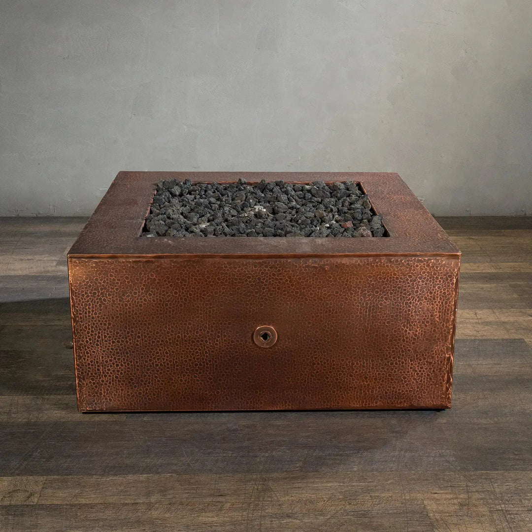 Front view of the Starfire Designs Moreno 36-inch square copper fire pit, unlit, showcasing the detailed hammered copper surface and deep fire bowl, perfect for enhancing contemporary outdoor living spaces