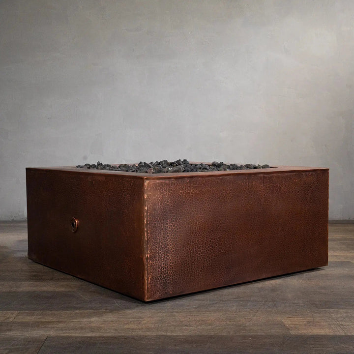 Starfire Designs Moreno 36-inch square copper fire pit, unlit, showcasing the intricate handcrafted hammered copper finish, ideal for modern outdoor spaces seeking a blend of elegance and durability