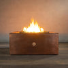 Starfire Designs Moreno 36-inch square copper fire pit with flames lit, showcasing hammered copper texture and radiant fire, perfect for outdoor ambiance