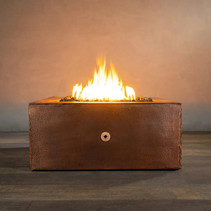 Starfire Designs Moreno 36-inch square copper fire pit with flames lit, showcasing hammered copper texture and radiant fire, perfect for outdoor ambiance