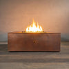 Luxury 45-inch square copper fire pit from Starfire Designs, the Gravity Moreno series, with a stunning central flame on lava rocks, perfect for modern outdoor patios and large backyard settings