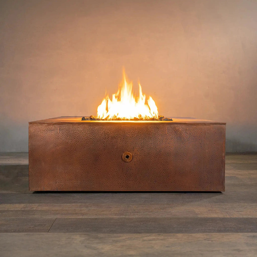 Luxury 45-inch square copper fire pit from Starfire Designs, the Gravity Moreno series, with a stunning central flame on lava rocks, perfect for modern outdoor patios and large backyard settings