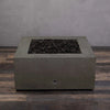 Front view of the Starfire Designs Rustic Gravity 36-inch Square Concrete Gas Fire Pit in brown, unlit, highlighting the modern design and lava rock filling