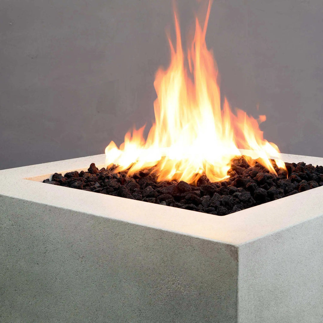 Corner view of the Starfire Designs Rustic Gravity 36-inch Square Concrete Gas Fire Pit in White, showcasing its minimalist design and flame performance