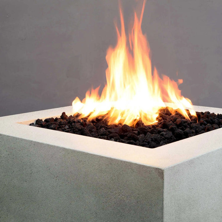 Corner view of the Starfire Designs Rustic Gravity 36-inch Square Concrete Gas Fire Pit in White, showcasing its minimalist design and flame performance