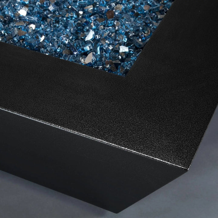 Close-up corner view of Starfire Designs Steel Mill 48-inch by 32-inch Rectangle Gas Fire Pit - Silver Vein with blue fire glass
