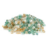A pile of Starfire Glass 1/2" Broken Pre-Mixed Fire Glass in Emerald Elegance, with a radiant mix of green, blue, and clear reflective fire glass. This heat-resistant fire glass enhances fire pits, fire tables, and outdoor fireplaces, adding a luxurious and vibrant flame display.