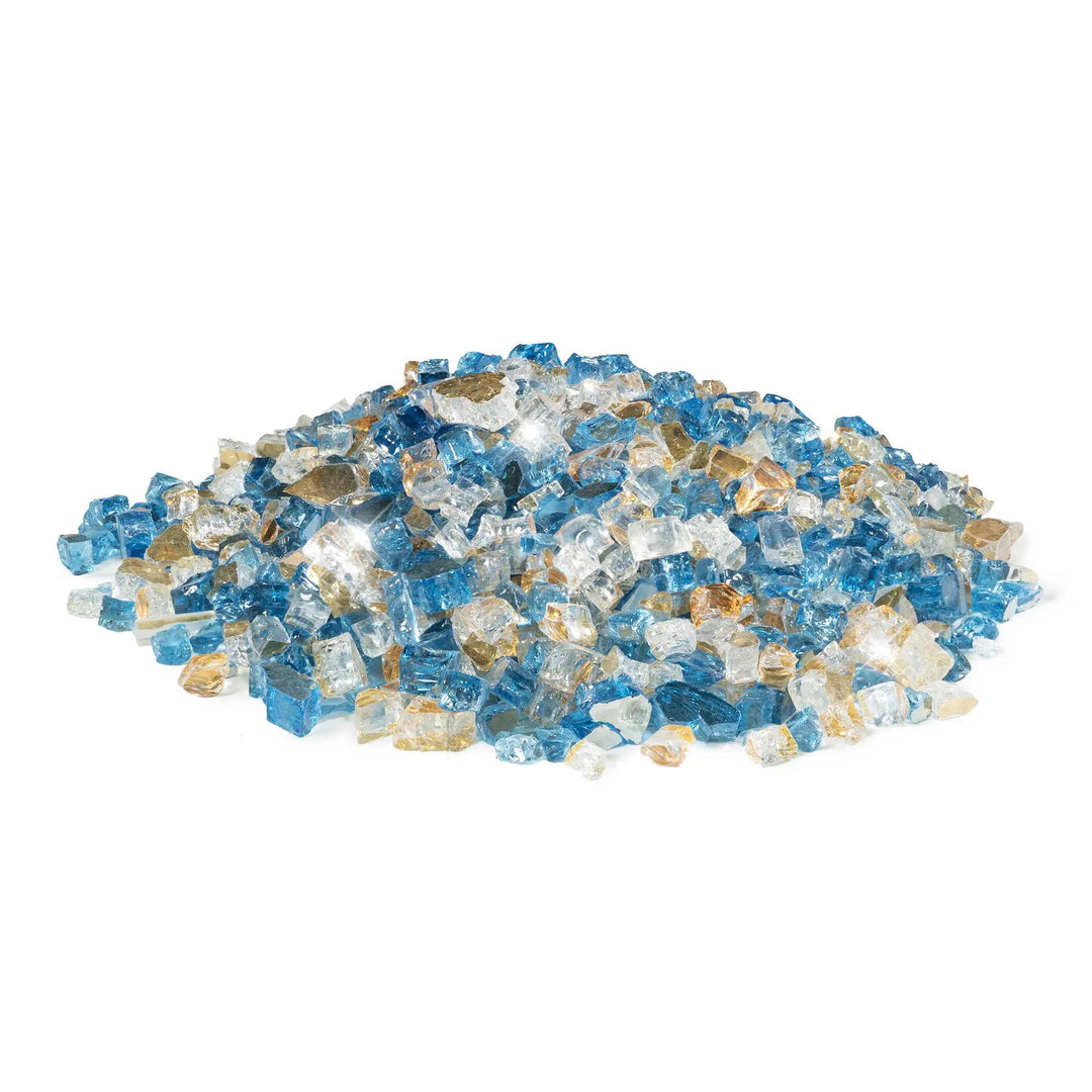 A loose pile of Starfire Glass 1/2" Broken Pre-Mixed Fire Glass in Pacific Sky, displaying a stunning blend of sky blue, clear, and gold-tinged glass pieces. Designed to withstand high temperatures, this fire glass enhances gas fire pits, fireplaces, and outdoor fire tables, providing a vibrant flame reflection.