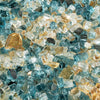Close-up view of Starfire Glass 1/2" Broken Pre-Mixed Fire Glass in Sunset Cove, a gorgeous mix of gold, amber, and light blue reflective pieces. This premium-quality glass adds a luxurious touch to outdoor fire pits, gas fireplaces, and fire bowls, amplifying the beauty of dancing flames.
