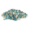 A loose pile of Starfire Glass 1/2" Broken Pre-Mixed Fire Glass in Sunset Cove, featuring an elegant blend of gold, clear, and soft blue-tinted glass. Perfect for modern fire pits, gas fire bowls, and fireplace inserts, this reflective glass creates a mesmerizing fire display while withstanding high temperatures.