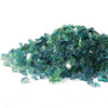 A stunning mound of Starfire Glass 1/4" Broken Pre-Mixed Fire Glass in Caribbean Blue (10lbs), showcasing a mix of deep ocean blue, teal, and clear fire glass. Designed for gas fire pits, fire bowls, and modern fire tables, this glass delivers a vibrant, beach-inspired aesthetic with exceptional heat resistance and longevity.