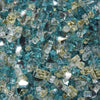 A close-up of Starfire Glass 1/4" Broken Pre-Mixed Fire Glass (10lbs) in Sunset Cove, displaying an elegant mix of amber, clear, and teal-colored glass. This fire glass is an excellent choice for luxury gas fire pits, modern outdoor fire bowls, and rectangle fire tables, providing a dynamic and colorful glow.