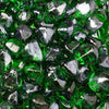 Vivid close-up of Starfire Glass Reflective Fire Diamonds in emerald green, showcasing a polished, reflective coating. These fire glass pieces add a lush, natural aesthetic to outdoor fire pits and modern fireplaces.