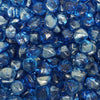 Close-up of Starfire Glass Reflective Fire Diamonds in Pacific Blue, featuring a stunning translucent blue with a glossy, mirrored surface. These fire glass gems provide a coastal, tropical feel to gas fire pits and outdoor fire features.