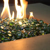 A fire pit burner pan filled with emerald green Starfire Glass Reflective Fire Diamonds, creating a mesmerizing blend of green fire glass and golden flames. The reflective surface intensifies the fire's glow, making it a stunning backyard fire feature for both propane and natural gas fire pits.