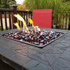 A luxurious fire pit filled with Starfire Glass Reflective Fire Diamonds in red, glowing against a black fire table on a cozy outdoor patio. The reflective fire glass enhances the flickering flames, creating a modern fire pit ambiance perfect for outdoor gatherings. Ideal for propane fire pits, natural gas fire pits, and fire tables.