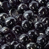 High-detail close-up of Starfire Glass Reflective Fire Drops in Black (10lbs), showcasing deep black, glossy, heat-resistant fire glass pebbles. Perfect for fire pits, gas fire tables, and contemporary fire features, adding a luxurious dark contrast.