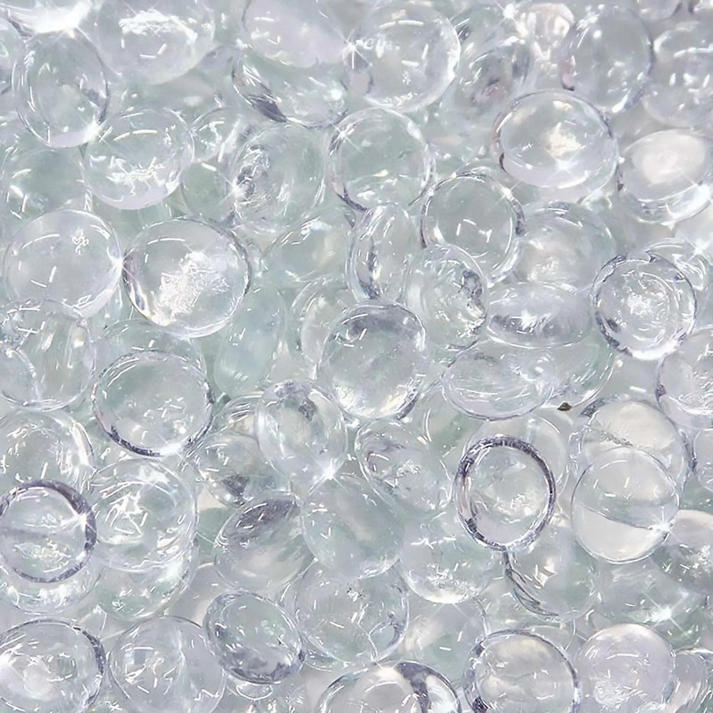 Close-up of Starfire Glass Reflective Fire Drops in Clear (10lbs), featuring crystal-clear, smooth, and polished heat-resistant fire glass. Enhances any fire pit, modern fire table, or outdoor fire feature with a shimmering effect.
