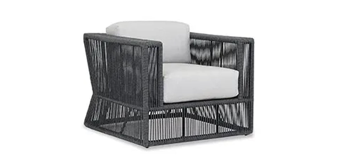 Contemporary outdoor lounge chair featuring a woven rope design and cushioned seating, perfect for modern patio settings