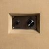 Close-up of the control panel on the Starfire Designs Beton 55-inch sand rectangle gas fire pit. The panel features an igniter button and an adjustable control knob for precise flame height adjustment. Encased in a recessed area within the sand-toned concrete, this detail highlights the user-friendly operation of this modern backyard fire pit