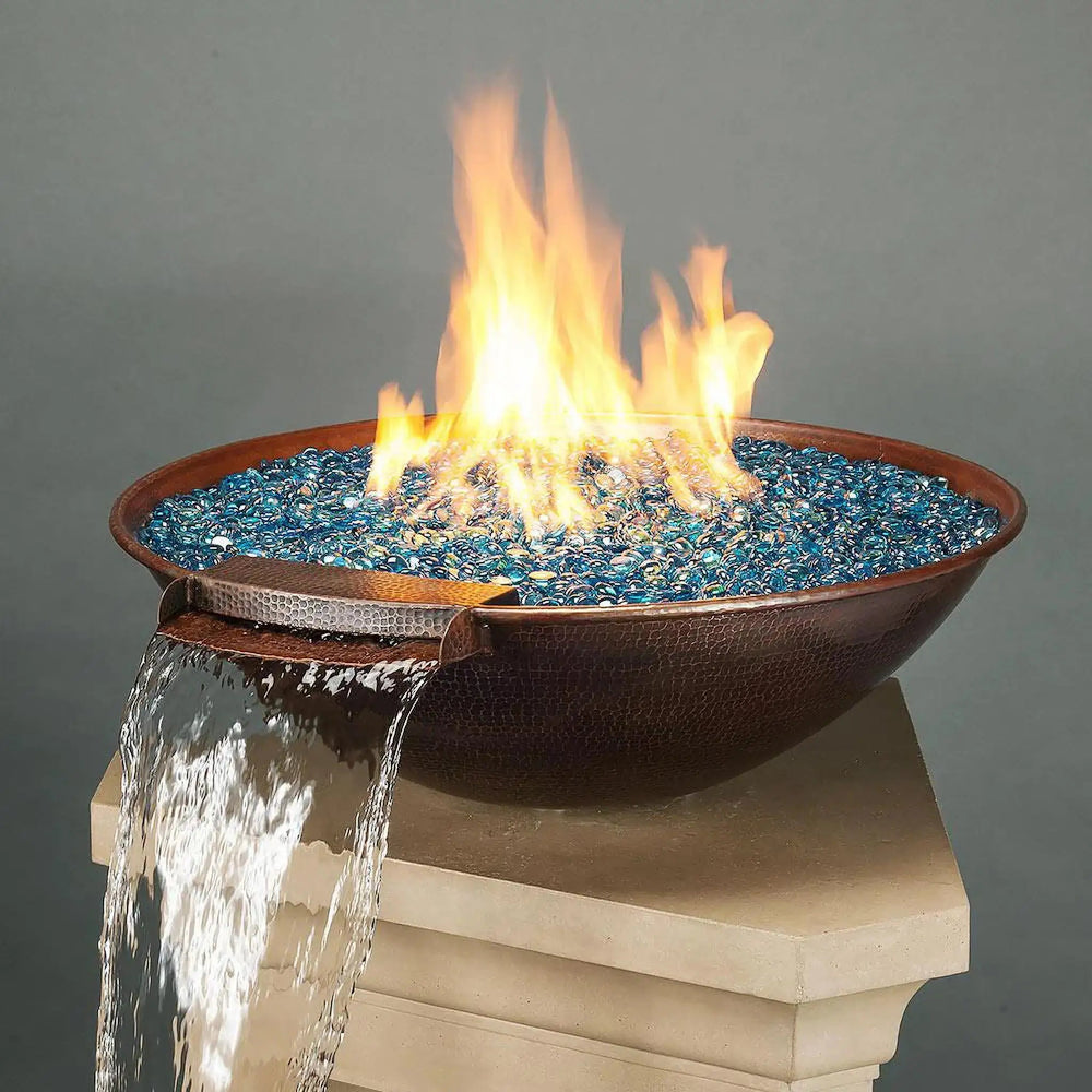 Taza Moreno 30-inch round copper fire and water bowl with blue fire glass, cascading water feature, and vibrant flames, a luxurious outdoor fire pit for modern backyards by Starfire Designs