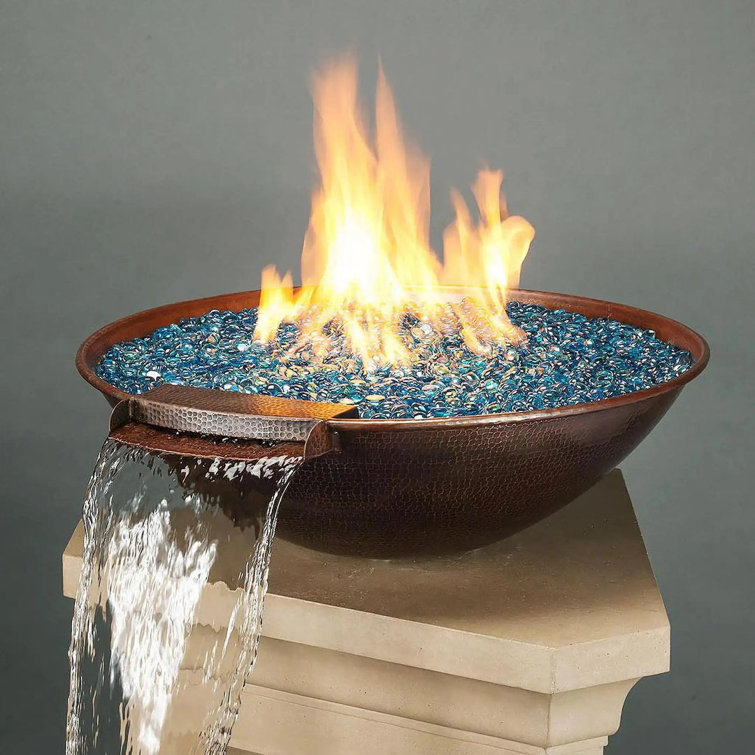 Taza Moreno 30-inch round copper fire and water bowl with blue fire glass, cascading water feature, and vibrant flames, a luxurious outdoor fire pit for modern backyards by Starfire Designs