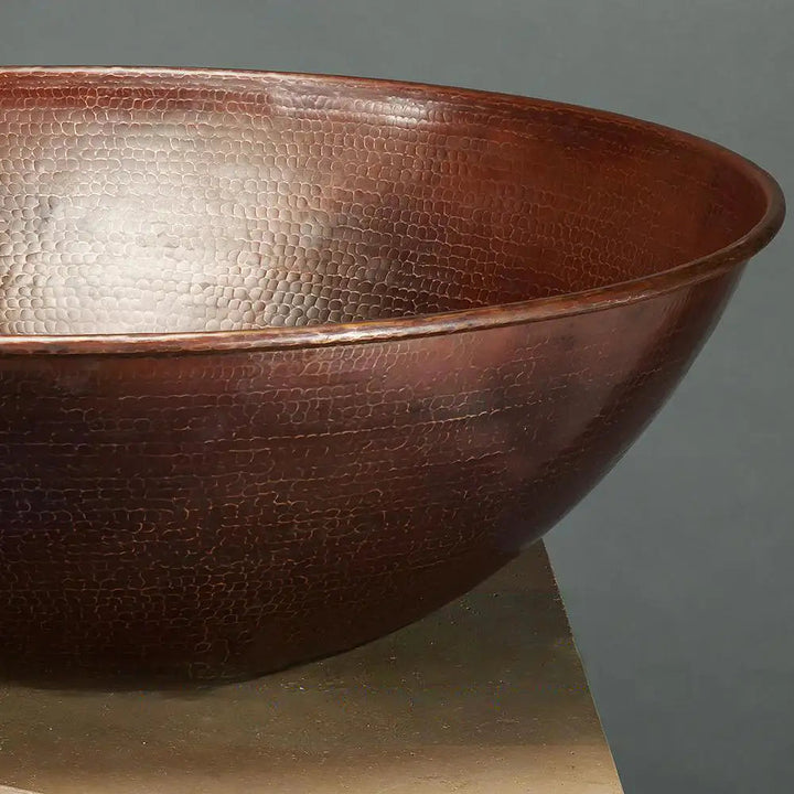 Close-up of the hand-hammered copper texture on the Taza Moreno 30-inch round copper water bowl, showcasing the intricate craftsmanship and luxury design of this outdoor water feature by Starfire Designs
