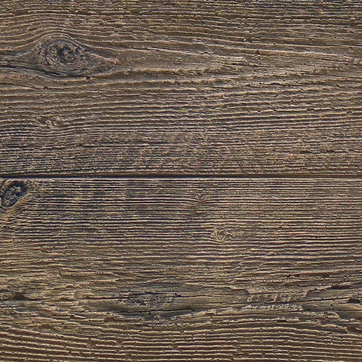 Close-up of The Outdoor Plus 108" Coronado wood grain concrete gas fire pit in Oak, highlighting the realistic wood grain texture molded into the concrete surface. This detailed texture mimics aged wood, giving the fire pit a rustic and natural aesthetic while maintaining the durability and strength of concrete. The perfect addition to outdoor spaces seeking a blend of modern functionality and rustic charm.