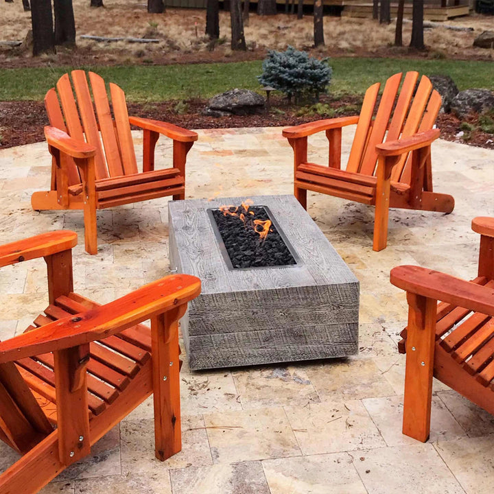 The Outdoor Plus 120-inch Coronado wood grain concrete gas fire pit in ivory, surrounded by outdoor seating in a patio setting. The fire pit’s large flame and wood grain textured finish add a luxurious yet rustic ambiance to outdoor gatherings, making it a functional centerpiece that operates on either propane or natural gas