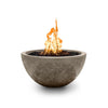 The Outdoor Plus 30" Luna Concrete Gas Fire Pit in Moss Stone finish, beautifully displayed with flames burning atop the fire pit's bowl. The rustic, organic texture of the concrete complements the natural outdoor environment, making it a perfect choice for patios, backyards, or commercial spaces. Ideal for creating a warm, inviting atmosphere in any outdoor area.