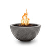 The Outdoor Plus 30-inch Luna Concrete Gas Fire Pit in Rustic Gray finish with fire ignited. The fire pit features a weathered gray concrete design, providing an earthy, rustic appeal perfect for outdoor patios or commercial spaces. Fueled by natural gas or propane, this fire pit is both stylish and functional, ideal for creating a cozy outdoor atmosphere. Includes black lava rock media for a striking fire display.