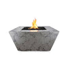The Outdoor Plus 36" Redan Concrete Gas Fire Pit in Rustic Gray, a weathered, textured finish that adds character to outdoor living areas. The clean, angular lines of the fire pit contrast beautifully with its rustic appearance, creating a harmonious blend of modern design and traditional aesthetics.