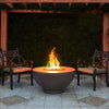 The Outdoor Plus 37-inch Sienna concrete gas fire pit displayed on a modern outdoor patio setting. The fire pit features a smooth round concrete design with a central gas burner, ideal for enhancing a backyard or garden environment. The flame dances over a bed of fire media, creating a warm and inviting ambiance. 