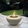 The Outdoor Plus 37-inch Sienna concrete gas fire pit beautifully showcased between two classic outdoor chairs in a luxury patio setting. The fire pit offers a spacious round design with a natural concrete finish, creating a perfect centerpiece for social gatherings. The flames rising from the pit provide both warmth and elegance to the surrounding space.
