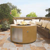 The Outdoor Plus 42-inch Chat Height Florence Concrete Gas Fire Pit displayed in an outdoor patio setting with cushioned seating. This gas fire pit, featured in a soft neutral color, adds warmth and ambiance to the outdoor space with its large circular shape and stainless-steel door for access to the internal propane tank. Ideal for backyard gatherings, this fire pit offers both style and functionality. Suitable for modern outdoor living spaces, it enhances the aesthetic while providing a convenient heat so